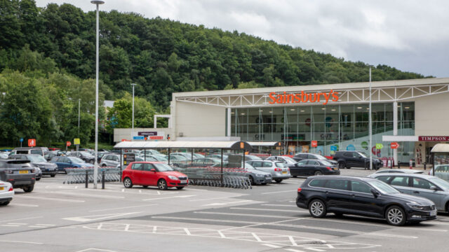 Exterior view of a Sainsbury store and parking lot