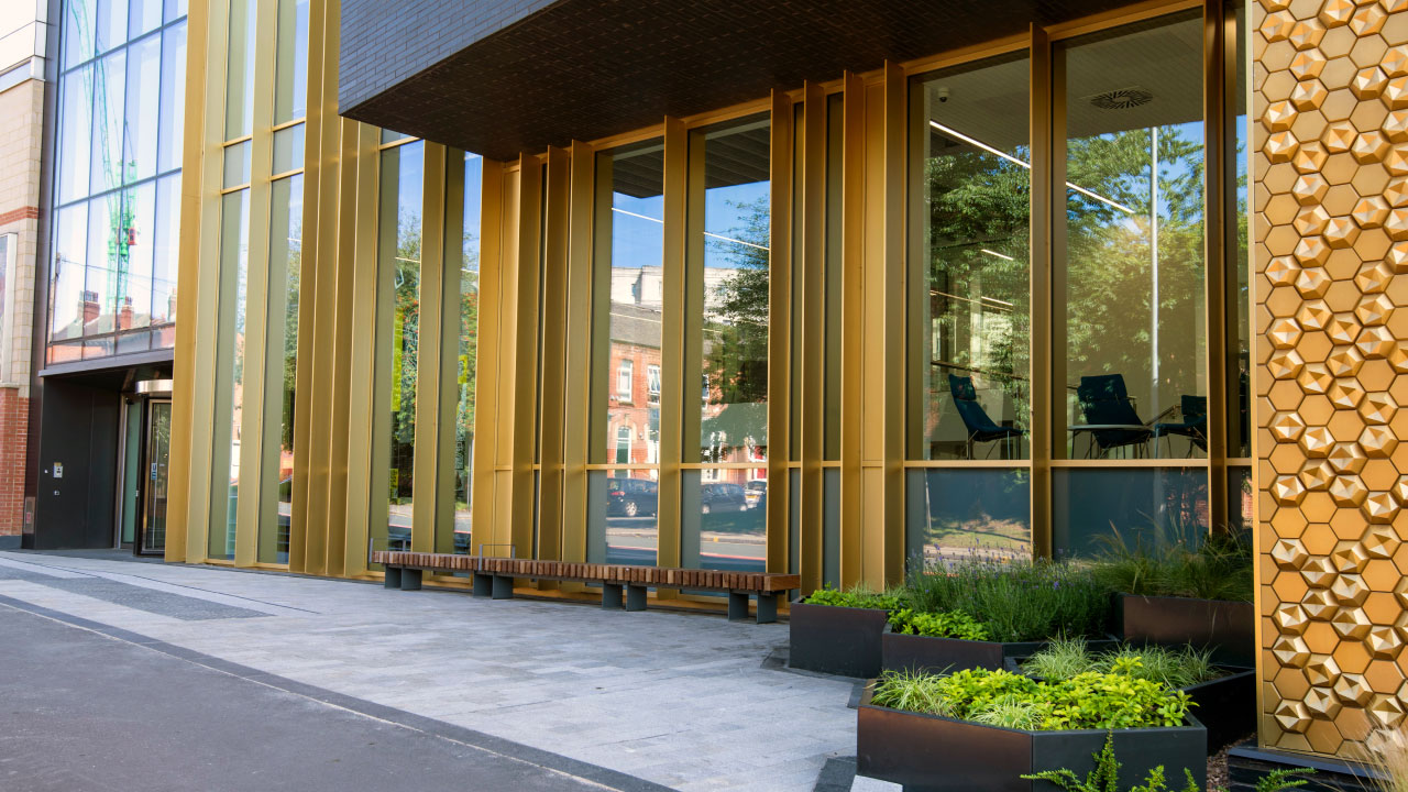 Front windows of a building with gold frames