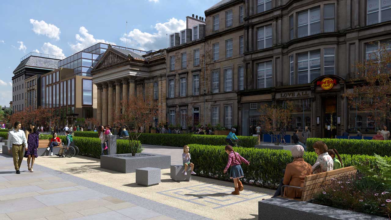 Children play near green bushes and people walk on pedestrian walkway with businesses in background