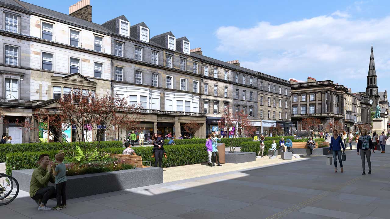 People walking on wide stone-paved street in front of buildings