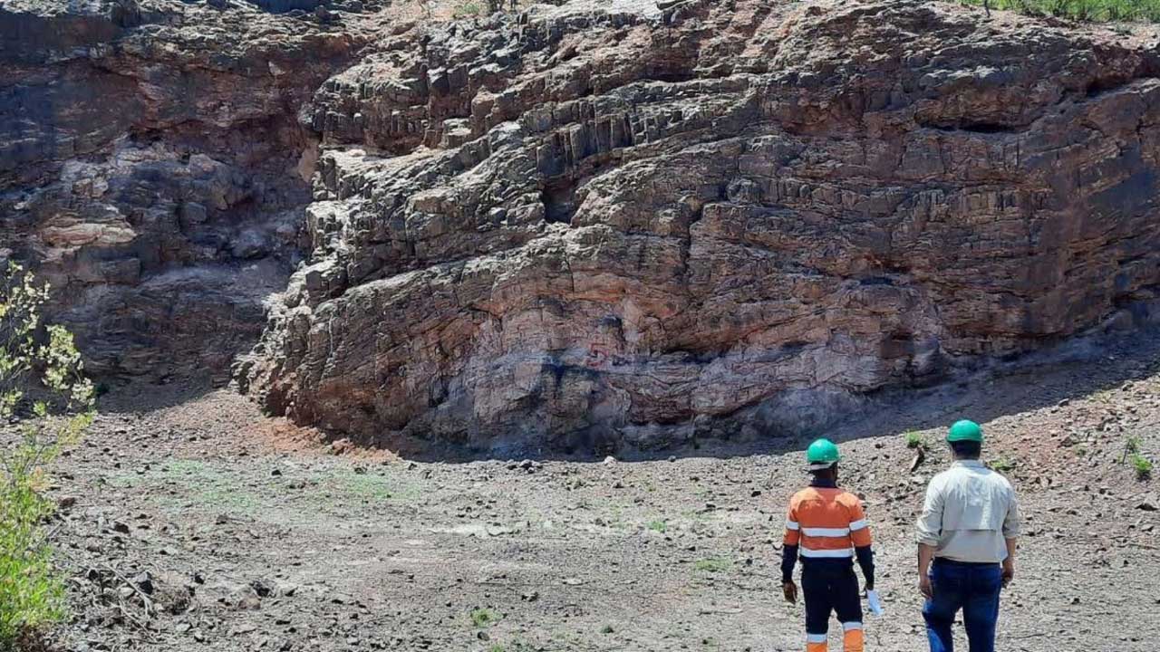 Two employees standing in front of mining site in Botswana