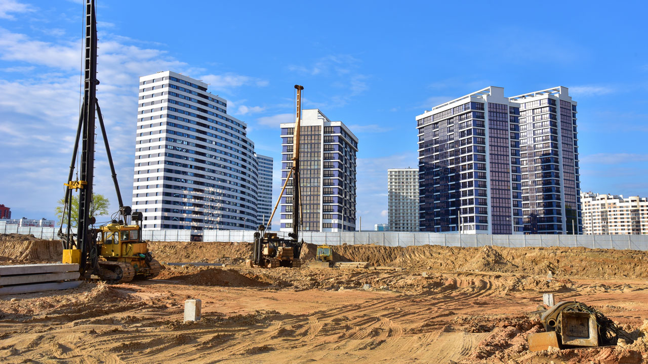 Several large buildings set against a blue skyline