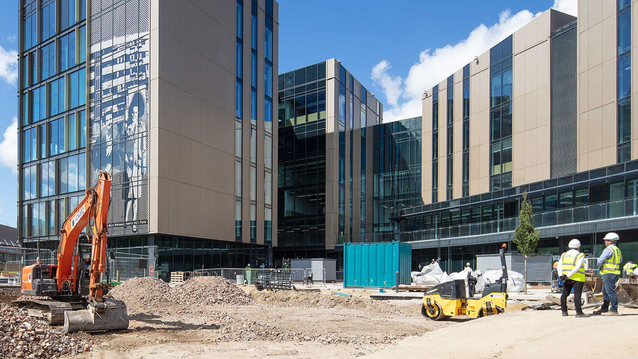 Work site in front of high-rise buildings under blue sky