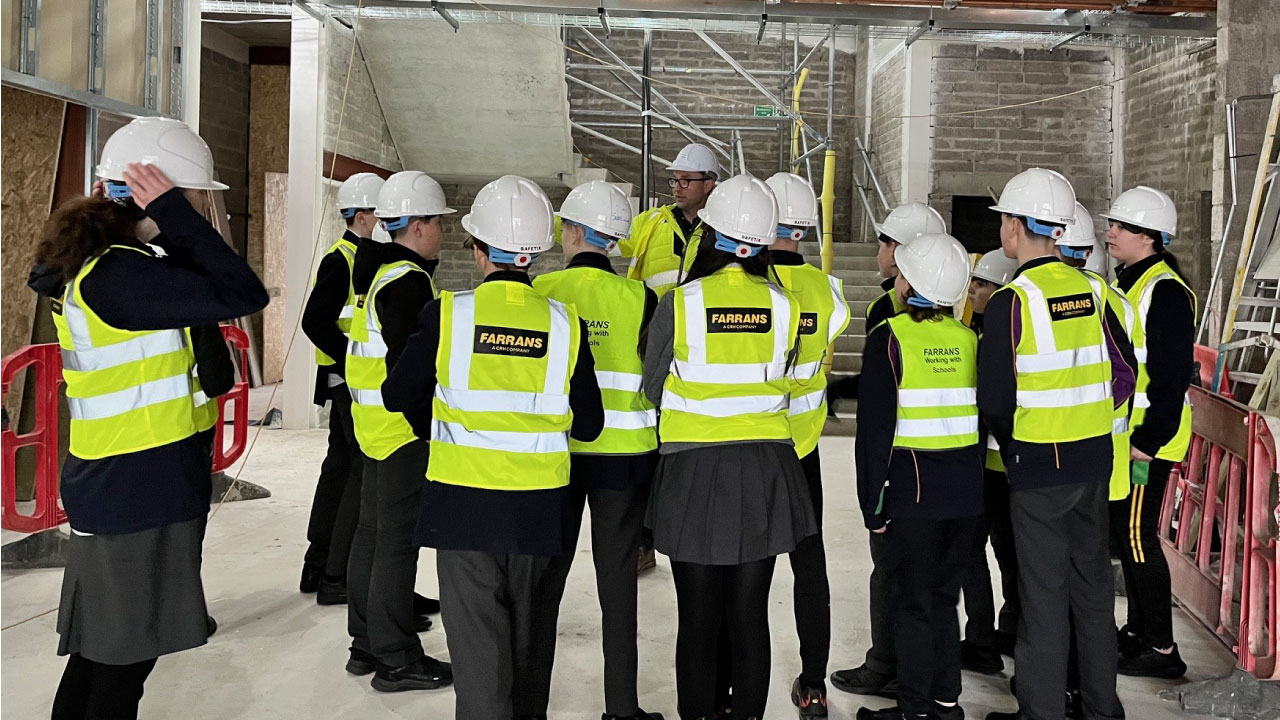 Children in PPE visiting a worksite