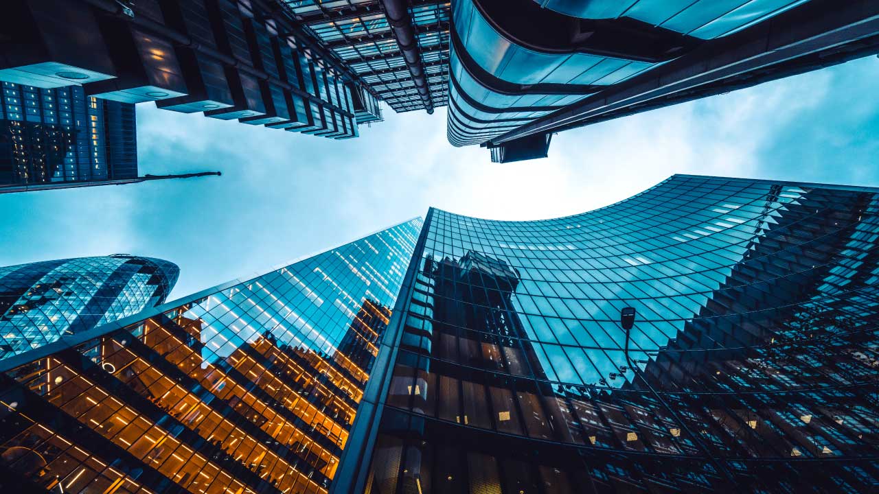 Tall buildings reflecting the surrounding scenery