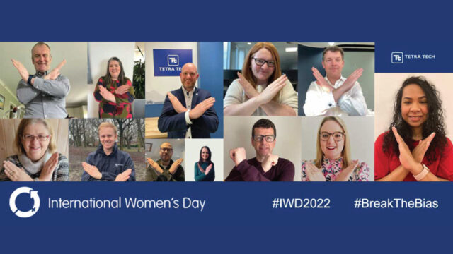 Tetra Tech employees holding out their hands in a “v” to symbolize “break the bias” for International Women’s Day 2022