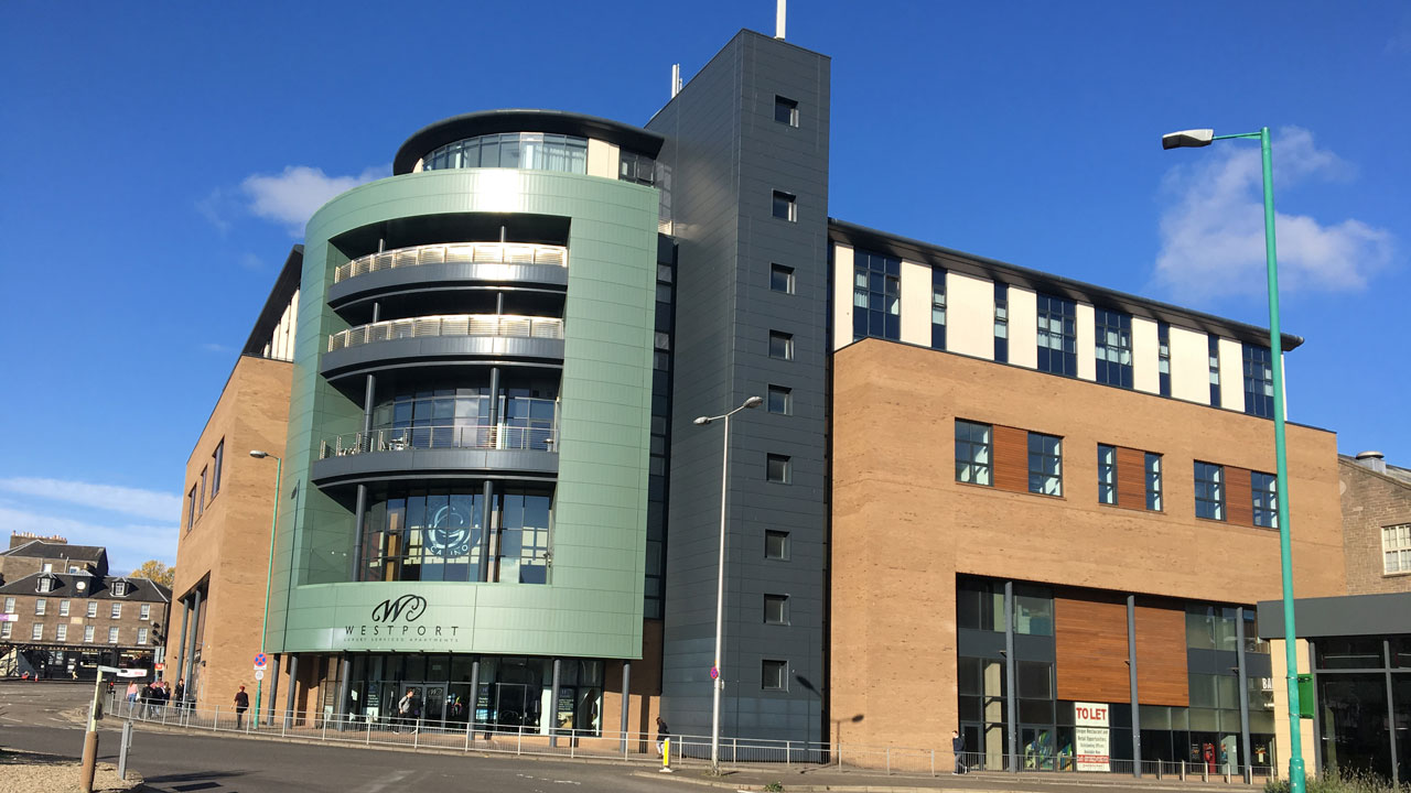 Exterior corner view of a modern style multistory retail building at an intersection