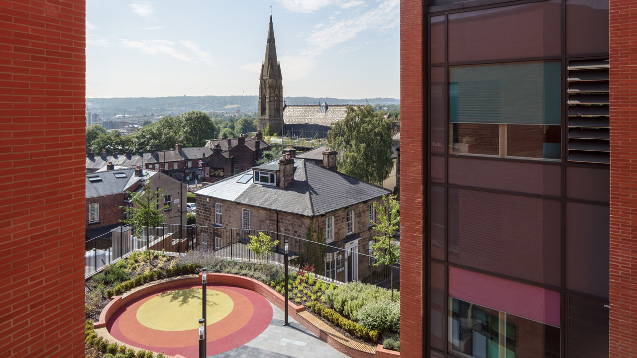 Aerial view of a colorful blob-shaped veranda overlooking the city